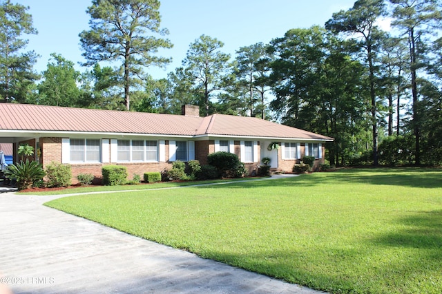 110 Joey St, Hampton, SC 29924 - single story home with brick siding, a front yard, a chimney, and metal roof