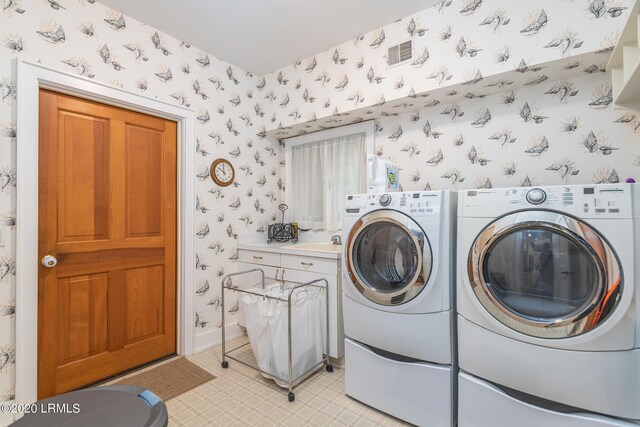 clothes washing area with sink and washer and clothes dryer