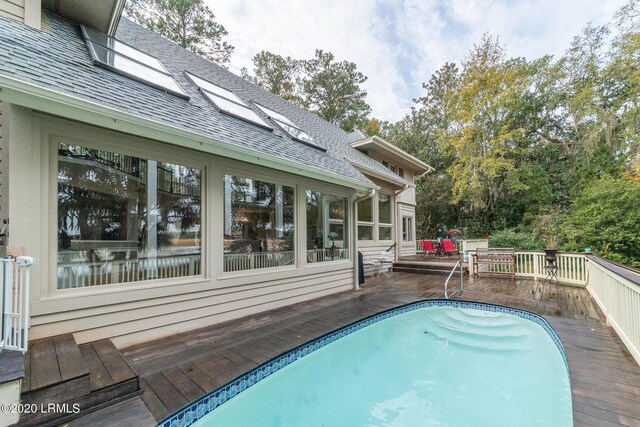 view of swimming pool featuring a wooden deck