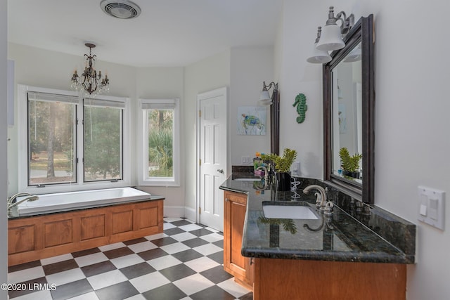 bathroom featuring vanity, a tub to relax in, and an inviting chandelier