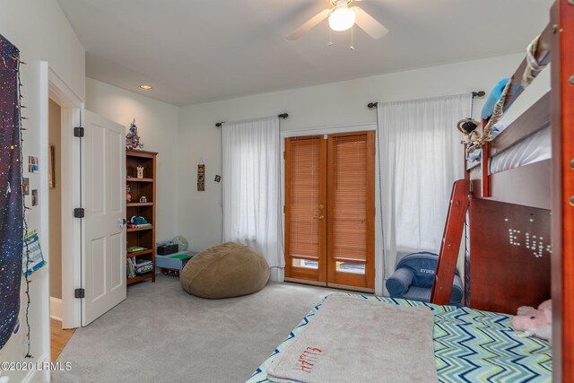 interior space with ceiling fan and light colored carpet