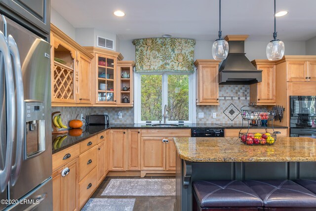 kitchen featuring pendant lighting, premium range hood, dark stone countertops, backsplash, and stainless steel fridge with ice dispenser