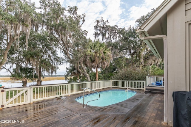 view of swimming pool featuring a deck with water view