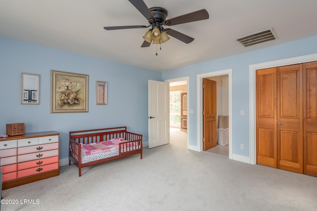 bedroom with light carpet, ceiling fan, and ensuite bathroom