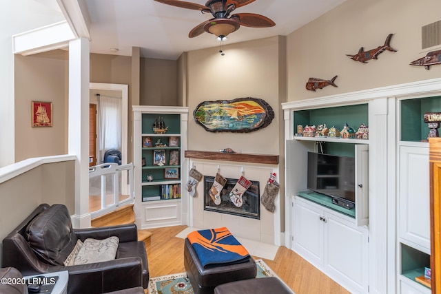 sitting room featuring ceiling fan and light wood-type flooring