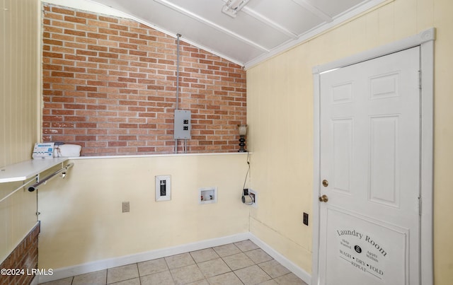 laundry room featuring light tile patterned floors, hookup for a washing machine, ornamental molding, and brick wall