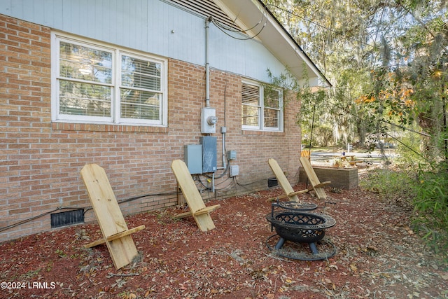 view of home's exterior featuring an outdoor fire pit