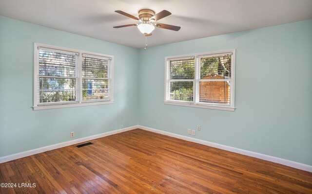 spare room featuring hardwood / wood-style floors and ceiling fan