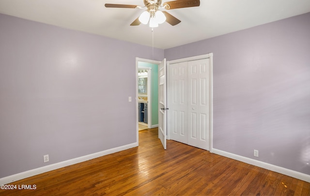 unfurnished bedroom with wood-type flooring, ceiling fan, and a closet