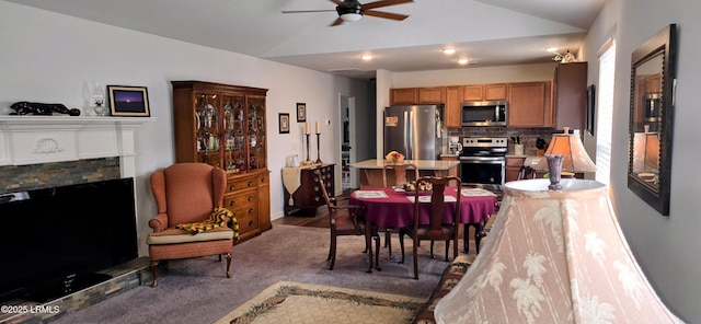 carpeted dining area with lofted ceiling and ceiling fan