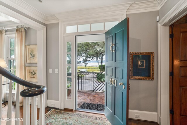 foyer entrance featuring ornamental molding and hardwood / wood-style floors