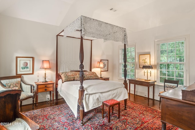 bedroom featuring vaulted ceiling and dark wood-type flooring