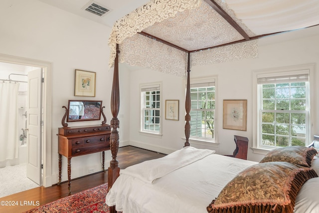 bedroom with dark hardwood / wood-style floors