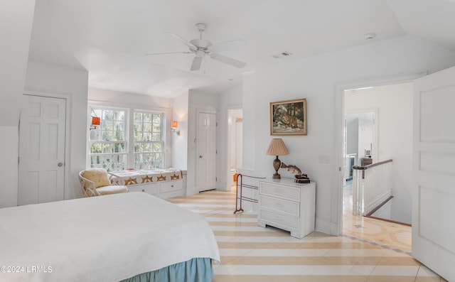 tiled bedroom with lofted ceiling and ceiling fan