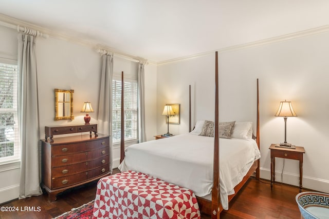 bedroom featuring ornamental molding and dark hardwood / wood-style floors