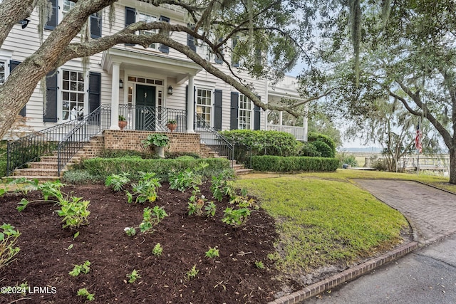 property entrance featuring a lawn