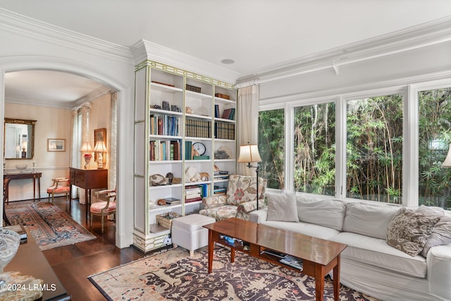 sitting room with dark wood-type flooring and crown molding