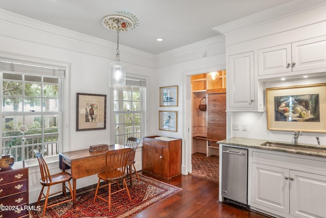 kitchen featuring pendant lighting, light stone counters, dishwasher, and white cabinets