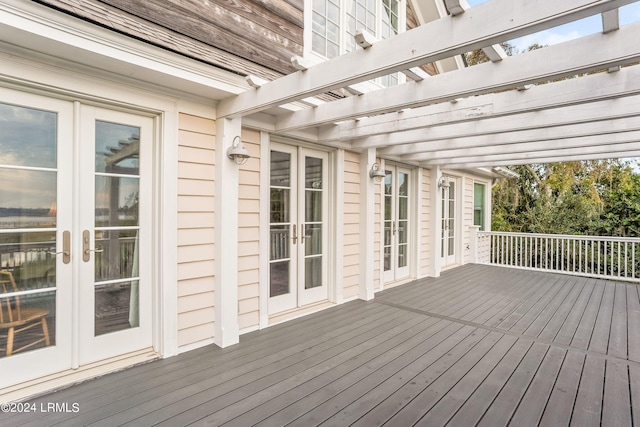 wooden terrace featuring a pergola and french doors