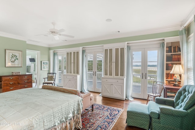 bedroom featuring ceiling fan, hardwood / wood-style floors, ornamental molding, access to outside, and french doors