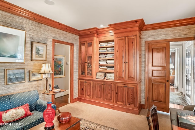 living room with ornamental molding and light colored carpet