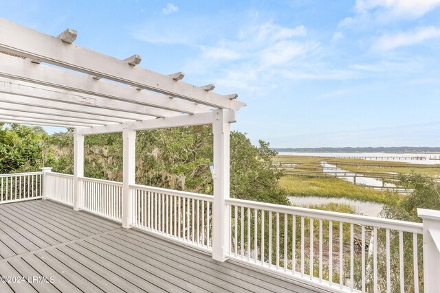 deck featuring a water view and a pergola