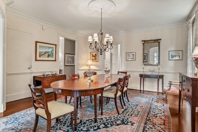 dining area with crown molding, hardwood / wood-style floors, and a notable chandelier