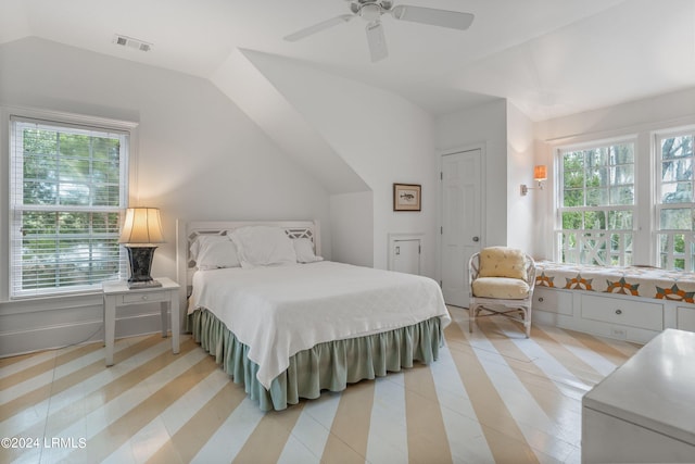 bedroom featuring multiple windows, vaulted ceiling, and ceiling fan