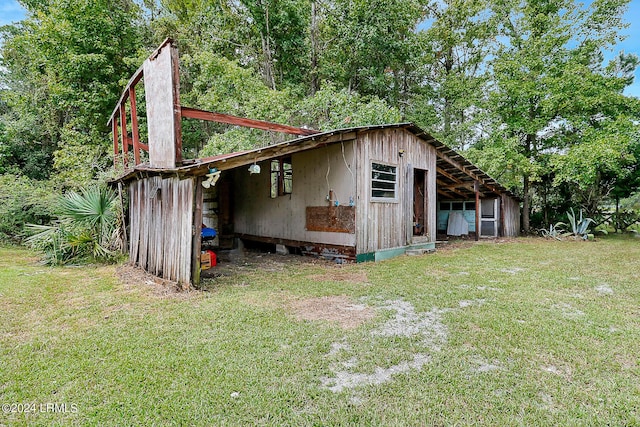 view of outbuilding with a yard