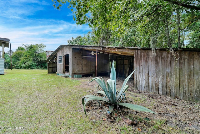 view of outbuilding featuring a yard