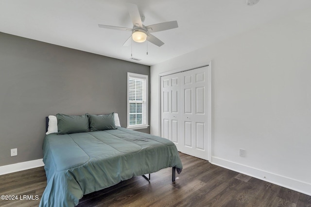 bedroom with ceiling fan, dark hardwood / wood-style flooring, and a closet