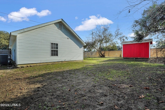 view of property exterior featuring central AC and a storage shed