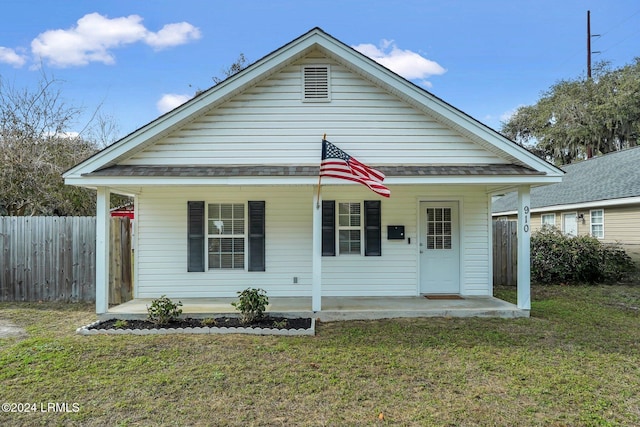 view of front of house with a porch and a front yard