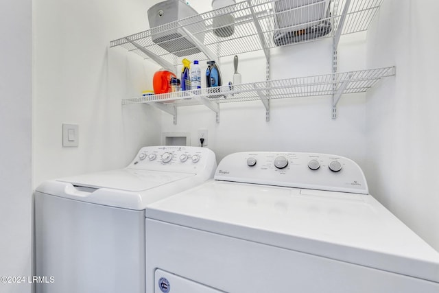 washroom featuring washer and clothes dryer