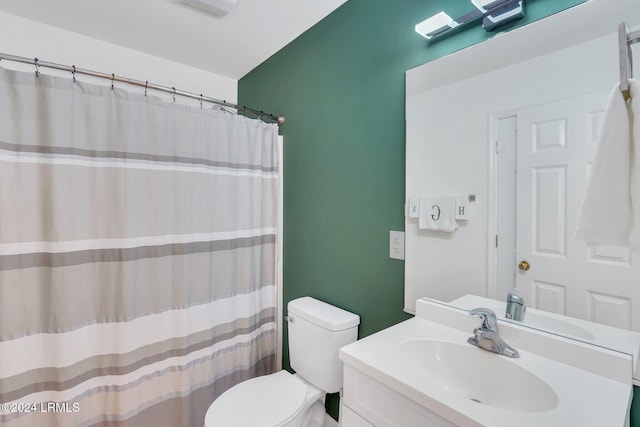 bathroom with vanity, toilet, and a shower with shower curtain