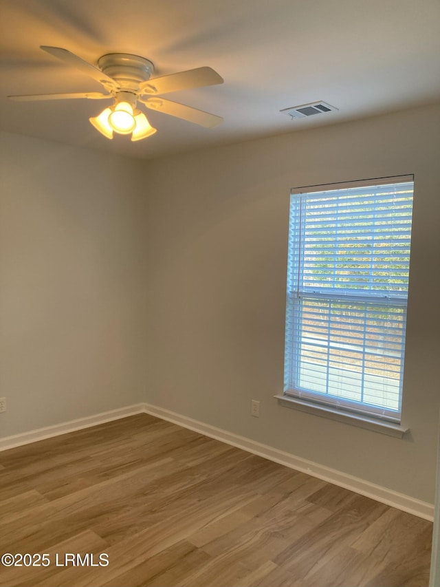 unfurnished room with hardwood / wood-style flooring and ceiling fan