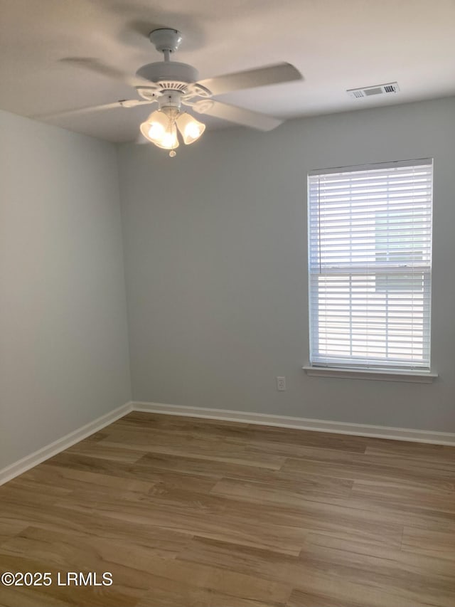 unfurnished room with hardwood / wood-style flooring and ceiling fan