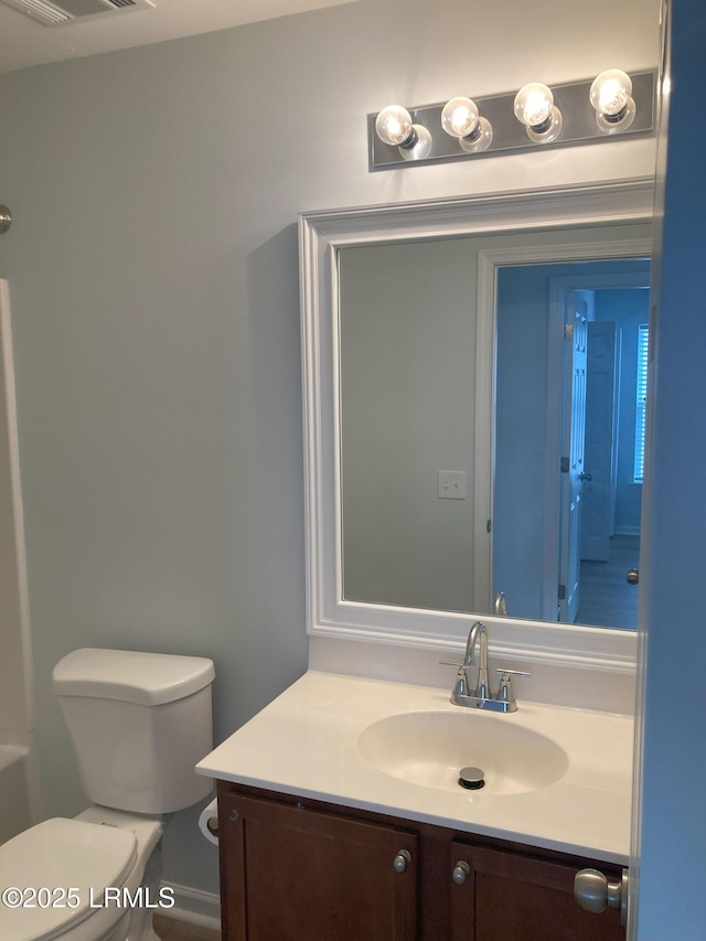 bathroom featuring vanity and toilet