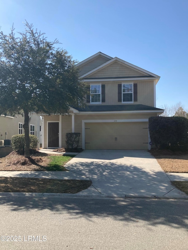 view of front of house featuring a garage and central AC