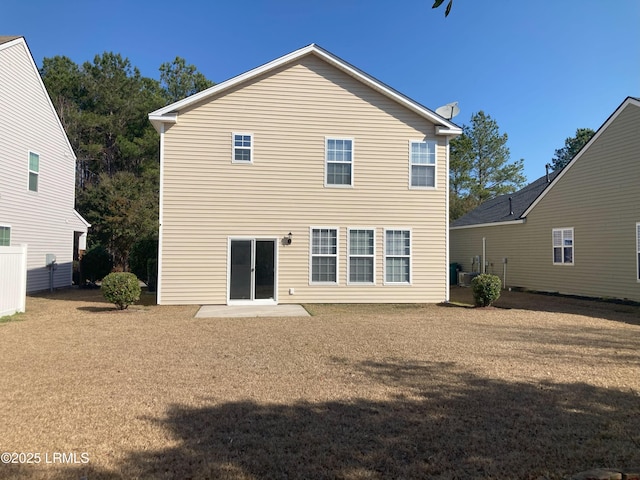 back of house featuring a yard and a patio area