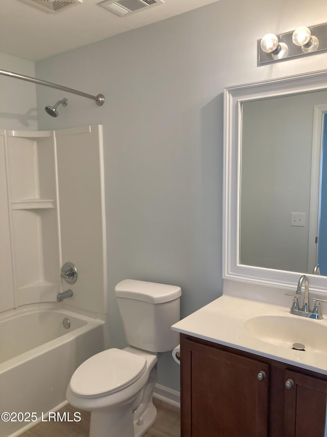 full bathroom featuring vanity, bathing tub / shower combination, and toilet