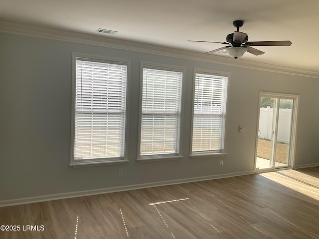 empty room featuring ceiling fan, ornamental molding, and wood-type flooring