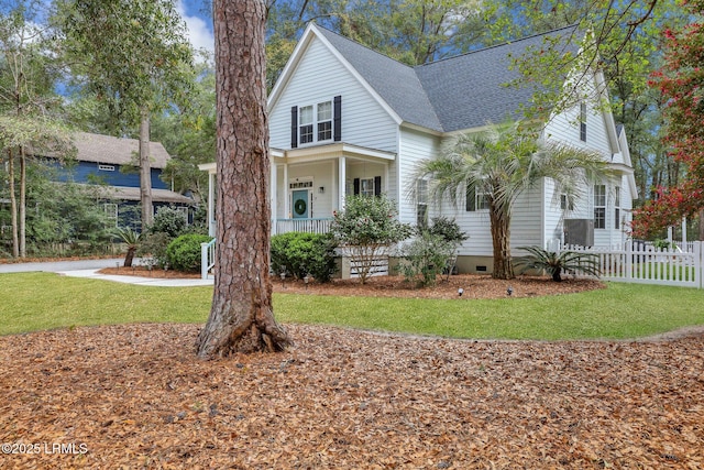 view of front of property with roof with shingles, a porch, a front yard, crawl space, and fence