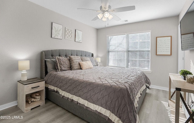 bedroom with ceiling fan and light wood-type flooring