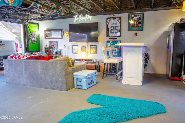 living room with bar and concrete flooring