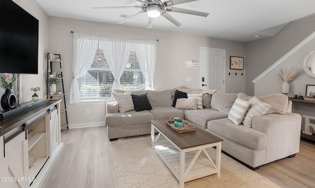 living room with ceiling fan and light wood-type flooring