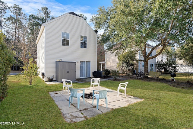 rear view of house featuring a yard and a patio