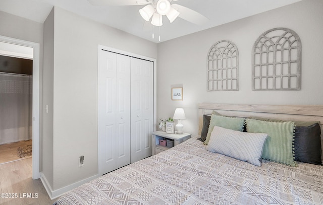 bedroom with ceiling fan, light wood-type flooring, and a closet