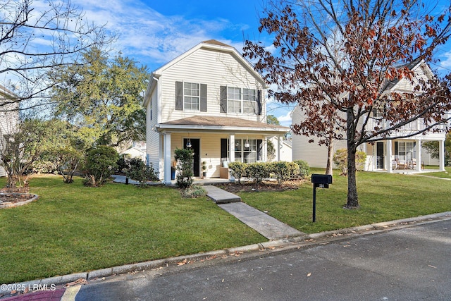 view of property featuring covered porch and a front lawn