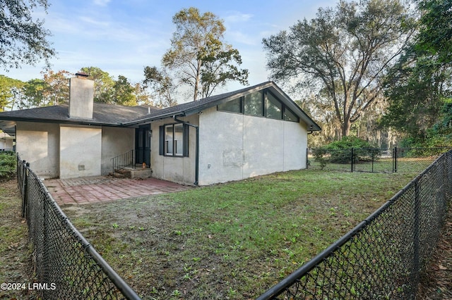 100 Thomas Sumter St, Beaufort, SC 29907 - rear view of property with stucco siding, a chimney, a fenced backyard, and a patio